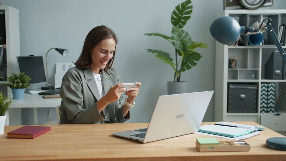 Three women in hijabs collaborating on digital advertising strategies around a table with laptops.